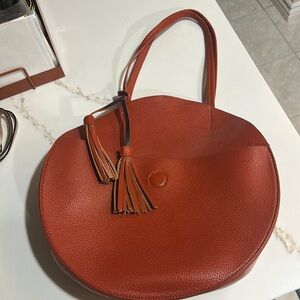 Beautiful burn orange round bag with pouch and cross body strap